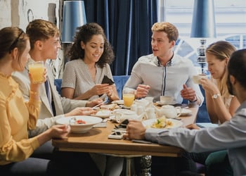 A group of friends sharing a meal around a table