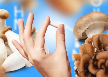 The image shows mushrooms and a hand holding a capsule.