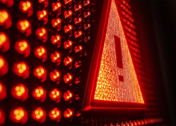 Red light bulbs and a danger sign in them in the dark