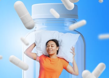 Person sleeping on a pillow with magnesium glycinate bottle in background