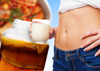 Persons stomach with heart hands near it with various foods for gut health