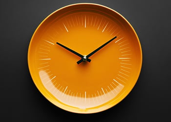 Orange clock in black background
