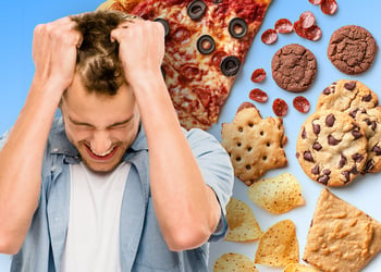 A stressed person surrounded by junk food