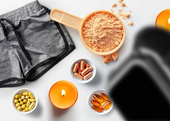 Gym shorts, paraffin wax candle, protein powder and herbal supplement pills