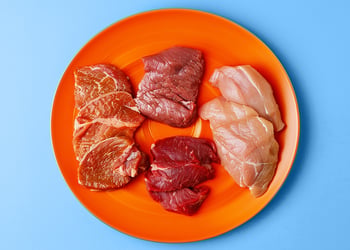 Different kinds of meat on a orange plate