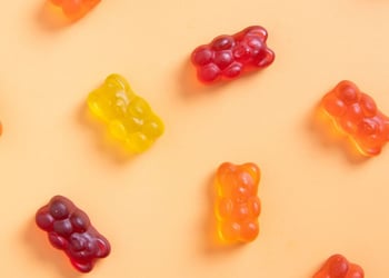 Colored jelly bears on an orange background.