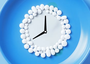 Clock made out of fasting supplements blue background