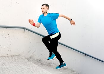 Person running up the stairs trying to build muscle