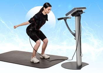 Person working out with ems machine hooked up