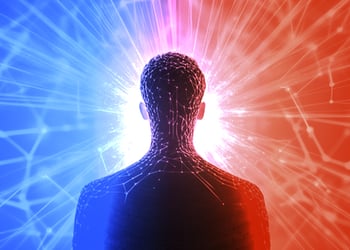 Person facing back with blue and red color illuminating from each side