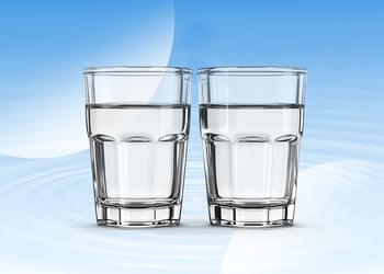 Two glasses of water in blue background
