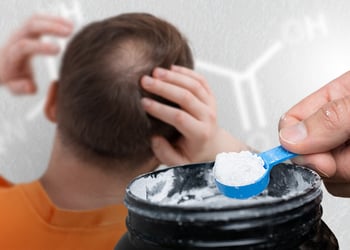 person checking their hair while a hand with creatine powder reaches out