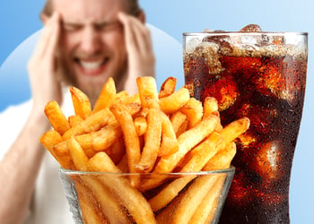 Person having migraine in background with mcdonalds food in front