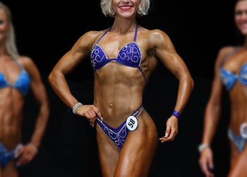 Muscular people on stage showing off their muscles