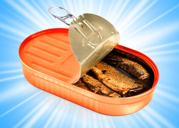 An opened can of sardines on a blue background