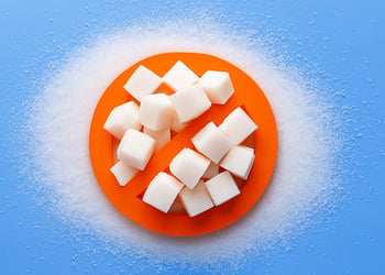 Sugar cubes on orange plate