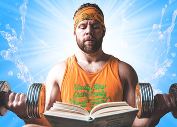 Person lifting dumbells with book in front