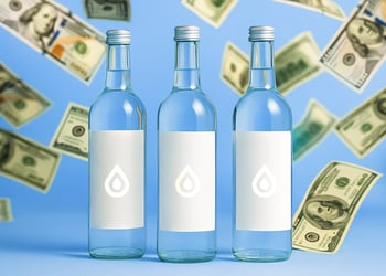 Three bottles of water with dollar bills around them on a blue background