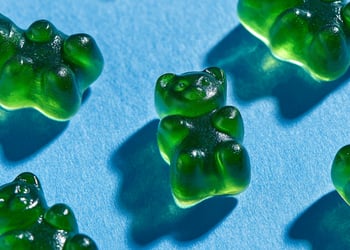 Green gummies in blue background