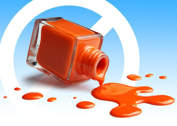 A glass bottle of orange gel nail polish and a prohibition symbol behind it