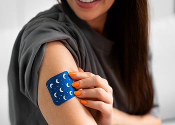 A person with a sleep patch on their arm