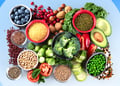 Different types of fiber, including broccoli, seeds and nuts, set against a blue background
