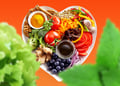 mix of vegetables, fruits, grain, nuts, herbs in a heart shape