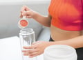 Person pouring powder into a shake